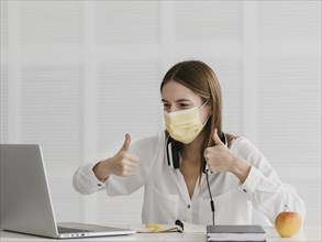 Teacher attending her online course wearing medical mask