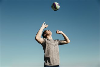 Man playing volleyball beach