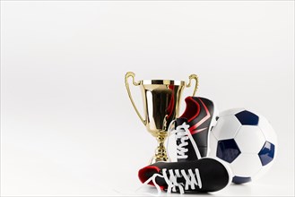 Football composition with shoes ball trophy