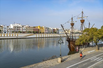 Replica of the Nao Victoria 500 and the colourful houses of the Triana district on the Guadalquivir River