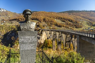 Statue of planner Mijat S. Trojanovic in front of the Tara Bridge in autumn