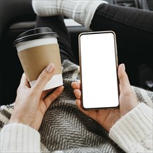 Front view woman holding blank phone cup coffee