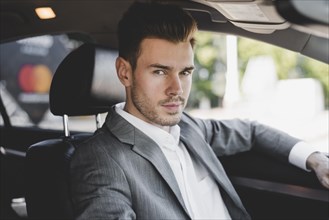 Handsome young businessman car