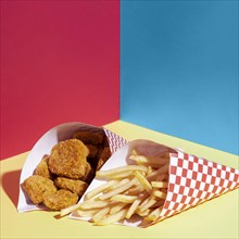 High angle arrangement with fries chicken nuggets