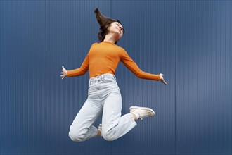 Portrait young woman jumping 2
