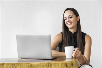 Woman smiling checking her laptop