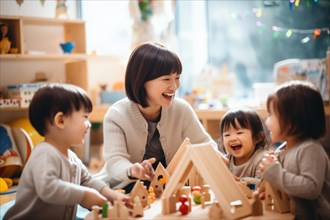 Children of Asian origin playing happily in kindergarten with kindergarten aunt