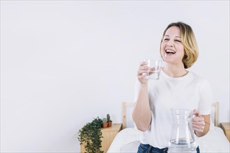 Laughing woman with water bedroom