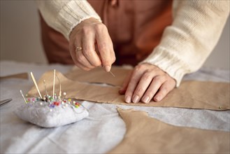 Tailor woman using needle thread sew