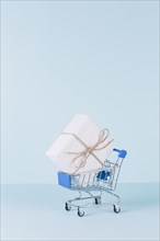 White package shopping cart blue background
