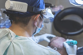 Hair transplant. Surgeons in the operating room carry out hair transplant surgery