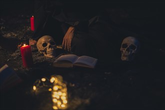 Witchcraft arrangement with candle lights dark