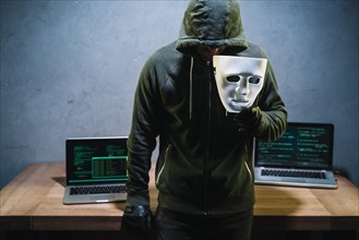 Hacker holding mask