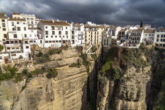 The white houses of the old town La Ciudad on a rocky plateau above the gorge Tajo de Ronda