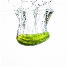Cucumber falling water water splash against white background