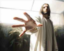 A person in the Jesus look stretches out his hand threateningly