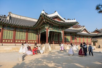 Young woman in traditional Hanbok dresses pose and take photographs