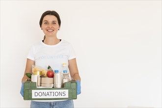 Female volunteer gloves handling box food donations