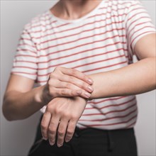 Mid section young woman having pain wrist