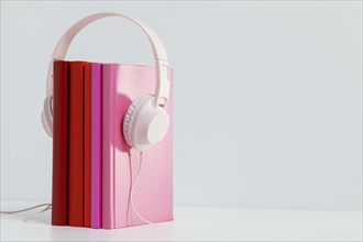 Colorful books with headphones copy space