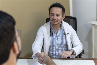 Latin doctor shaking hand to his patient