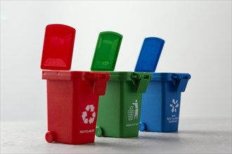 Three miniature recycle bins