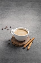 High angle coffee cup with cinnamon sticks copy space
