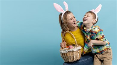 Copy space happy mother son with basket painted eggs