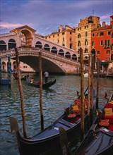 Sunset view of famous bridge of Rialto or ponte di Rialto on Grand Canal