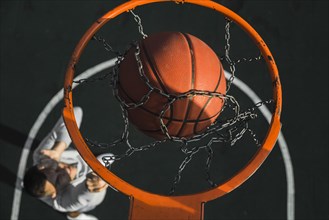 Basketball falling through ring