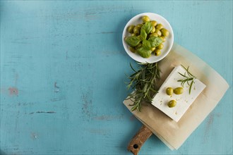 Blue background olives cheese aromatic herb