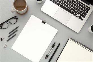 Arrangement desk elements with empty notebook grey background