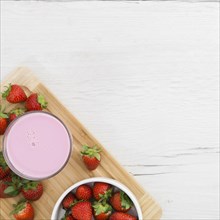 Flat lay strawberry smoothie with fruits