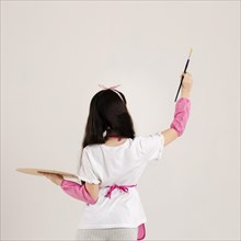 Young girl painting back view