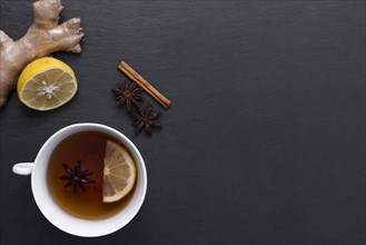 Lemon tea with ginger cinnamon beside