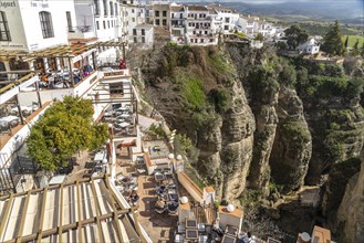 Restaurants high above Tajo de Ronda gorge and the white houses of La Ciudad old town