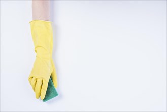 Janitor s hand with yellow gloves holding sponge white background