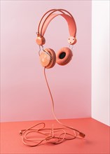 Pink headphones with cable flying