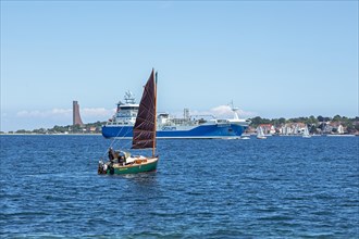Sailing boat and cargo ship off Laboe