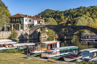 Excursion boats at the Old Bridge Stari Most over the river Crnojevic in Rijeka Crnojevica