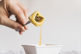 Hand with bread cheese fondue pick