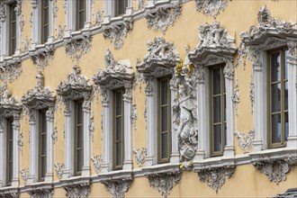 Windows of the Falcon House with stucco facade and rococo-style sculptures in the centre of Wuerzburg