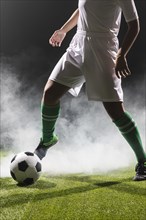 Fit woman playing soccer ball