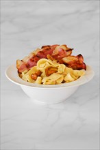 Mushroom pasta with chanterelle and bacon on a plate