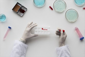 Close up scientist holding pipette