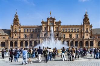 Tourists at the fountain in the Plaza de Espana in Seville