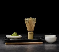 Front view matcha tea with bamboo whisk