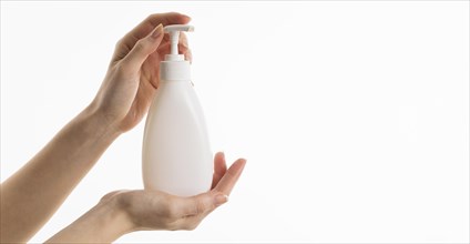 Hand holding liquid soap bottle with copy space