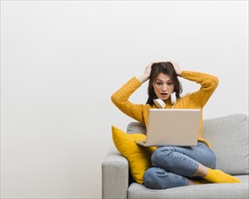 Woman sitting sofa made mistake her laptop