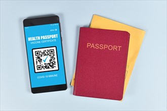 Concept for international Corona virus vaccine passport on mobile phone device to allow vaccinated people privileges like traveling